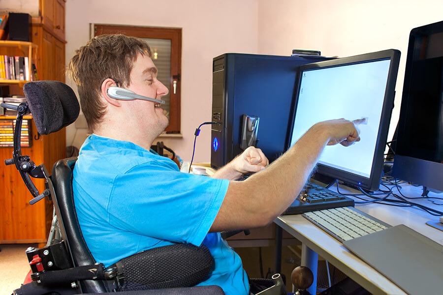 Young man with a disability using a computer