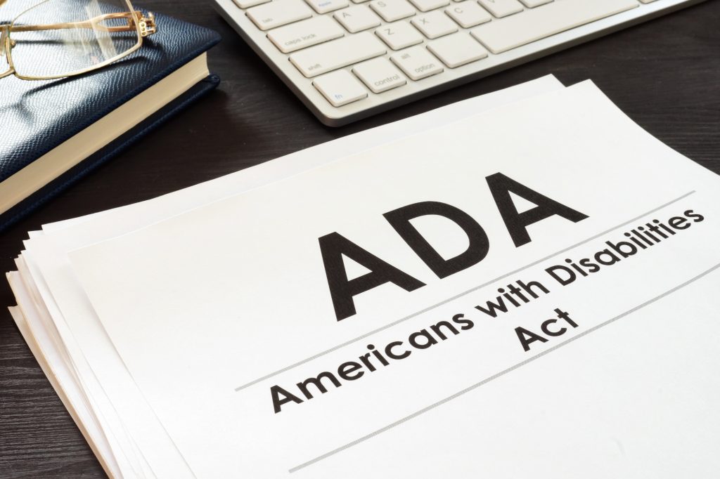 papers with ADA Americans with Disabilities Act on the front